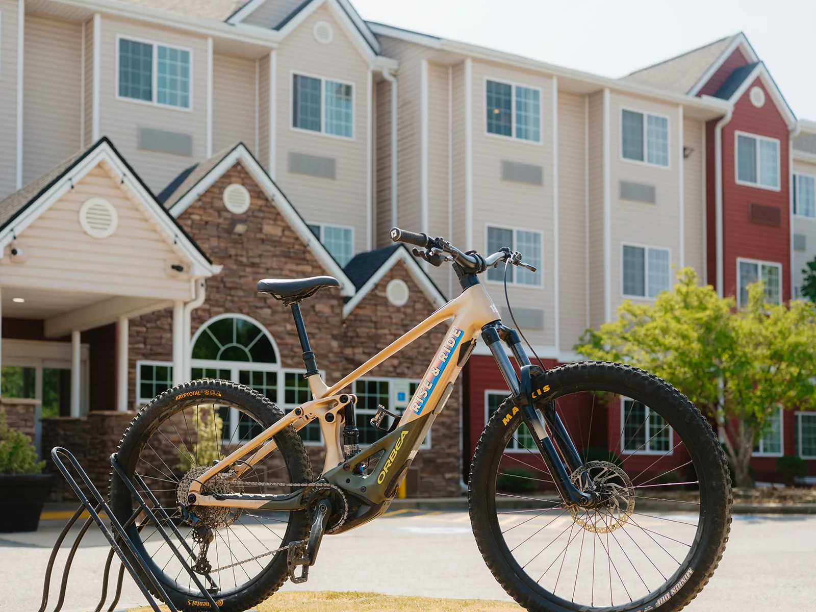 RISE & RIDE branded mountain bike parked outside THE BLOCK HOTEL for guest use