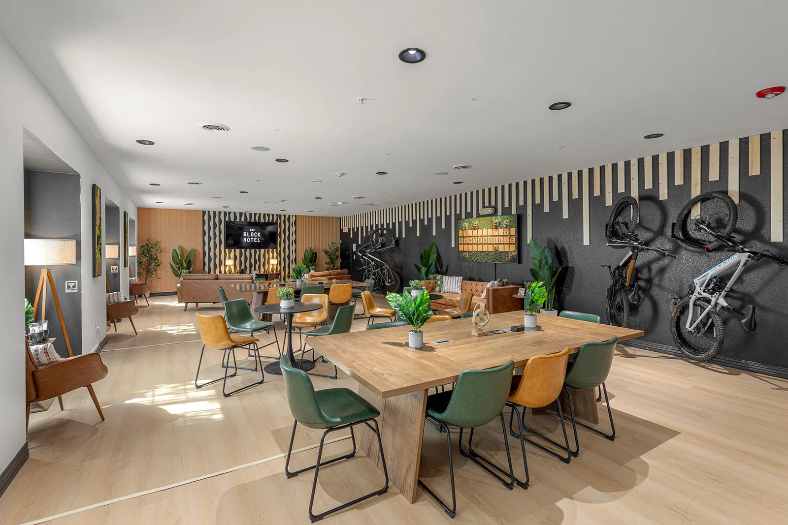 The Vibe Lounge communal work tables with mountain bikes mounted on the wall